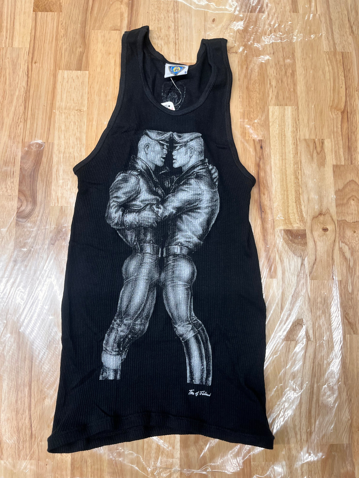 A tank top of the Famous art by Tom of Finland of a “Leather “ Duo in a very intimate proximity 